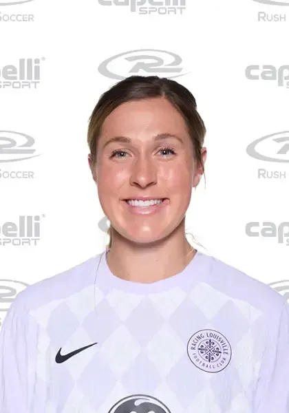 A woman is wearing a white nike shirt and smiling