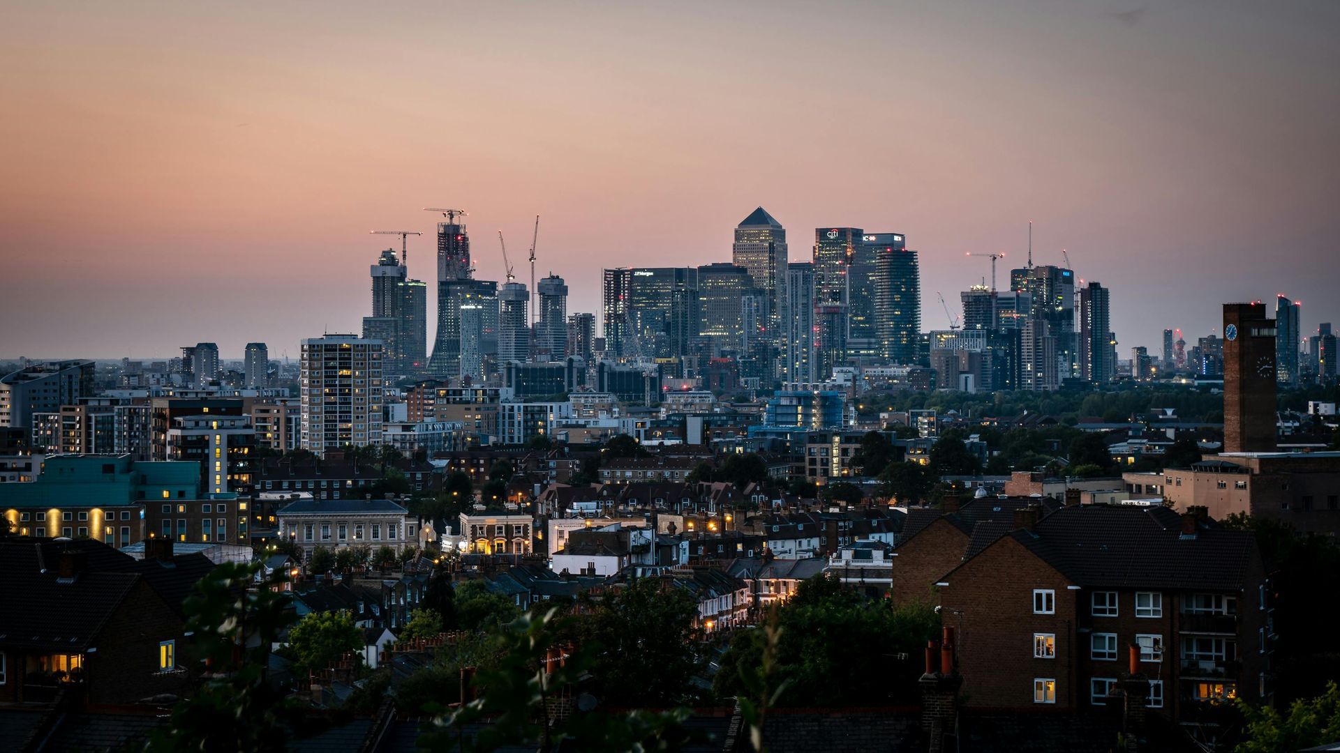 An aerial view of a city skyline at sunset.