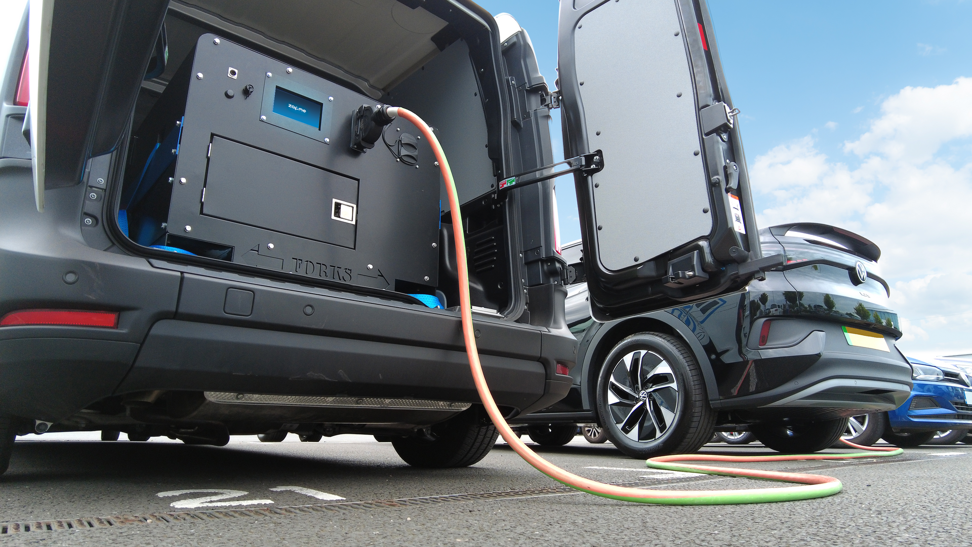 A van is being charged with a hose attached to it.