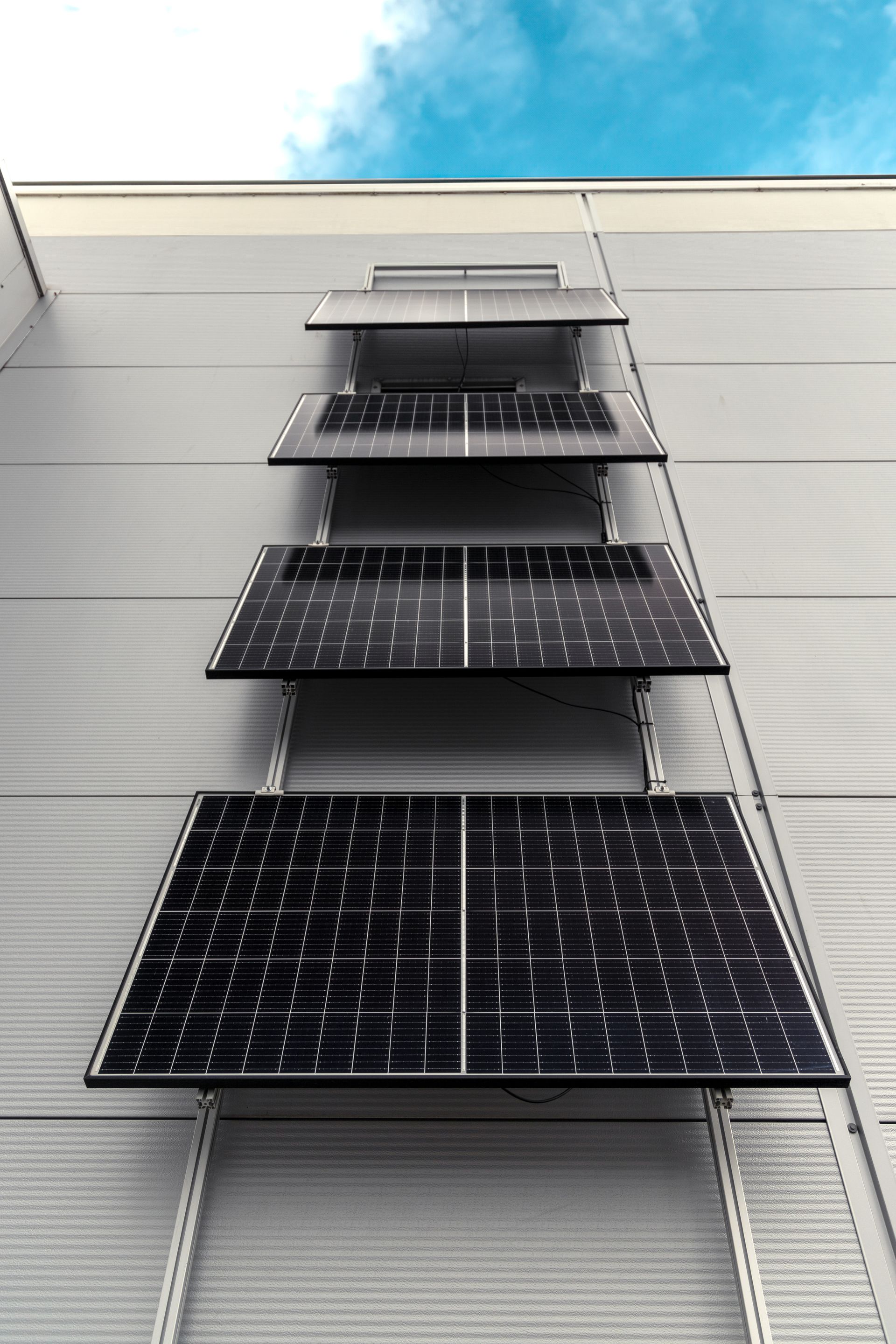 A row of solar panels on the side of a the ZPN building.