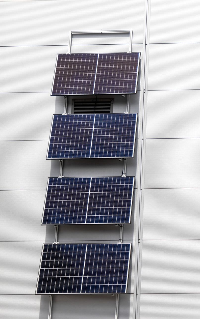 A row of solar panels on the side of a building