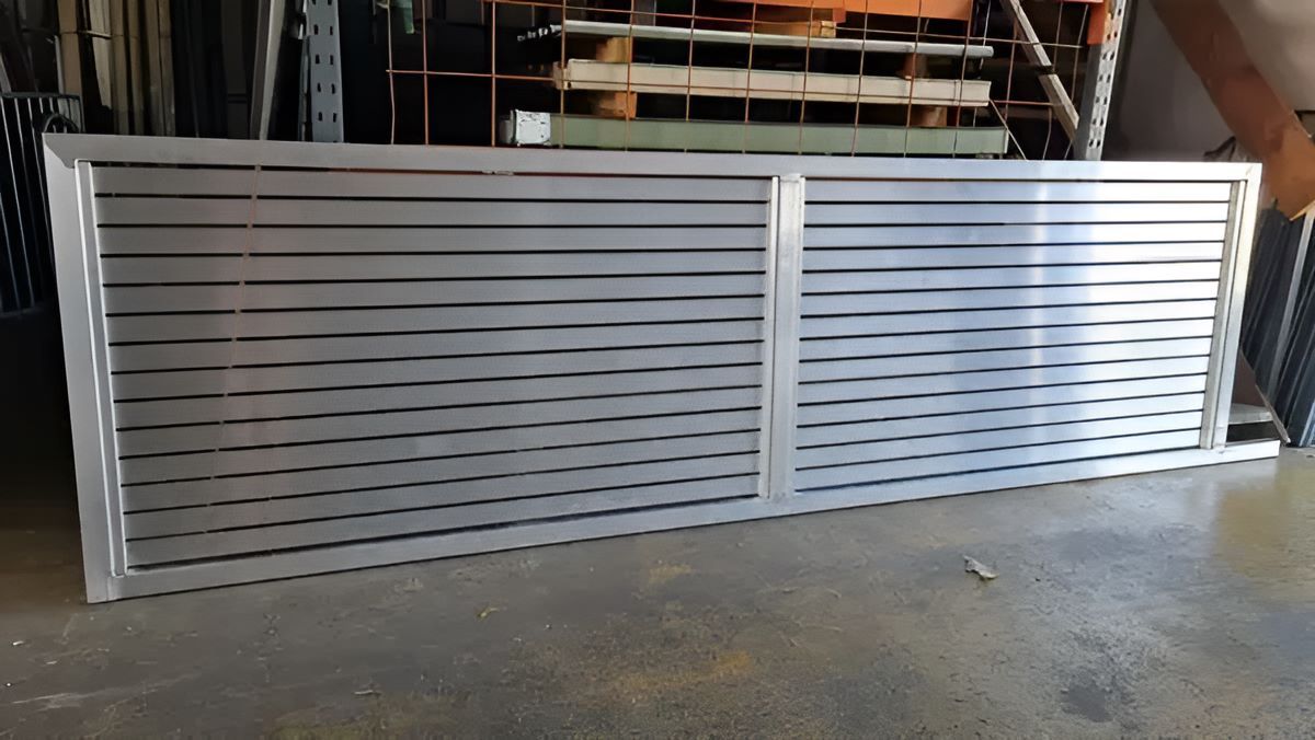 A Large Piece Of Metal Fence Is Sitting On The Floor In A Warehouse — Metal Fencing Supplies in Taree, NSW