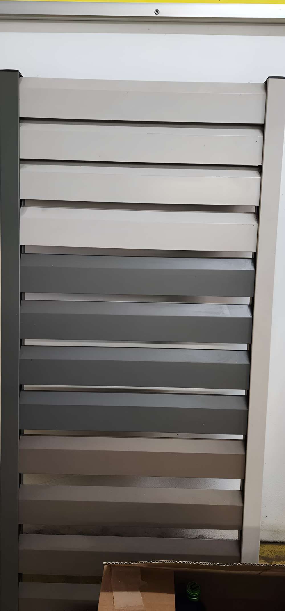 A Gray And White Fence Is Sitting Next To A Box — Metal Fencing Supplies in Forster, NSW