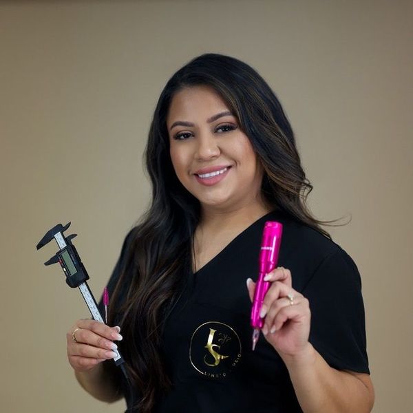 A woman in a black shirt is holding a pink pen and a digital caliper