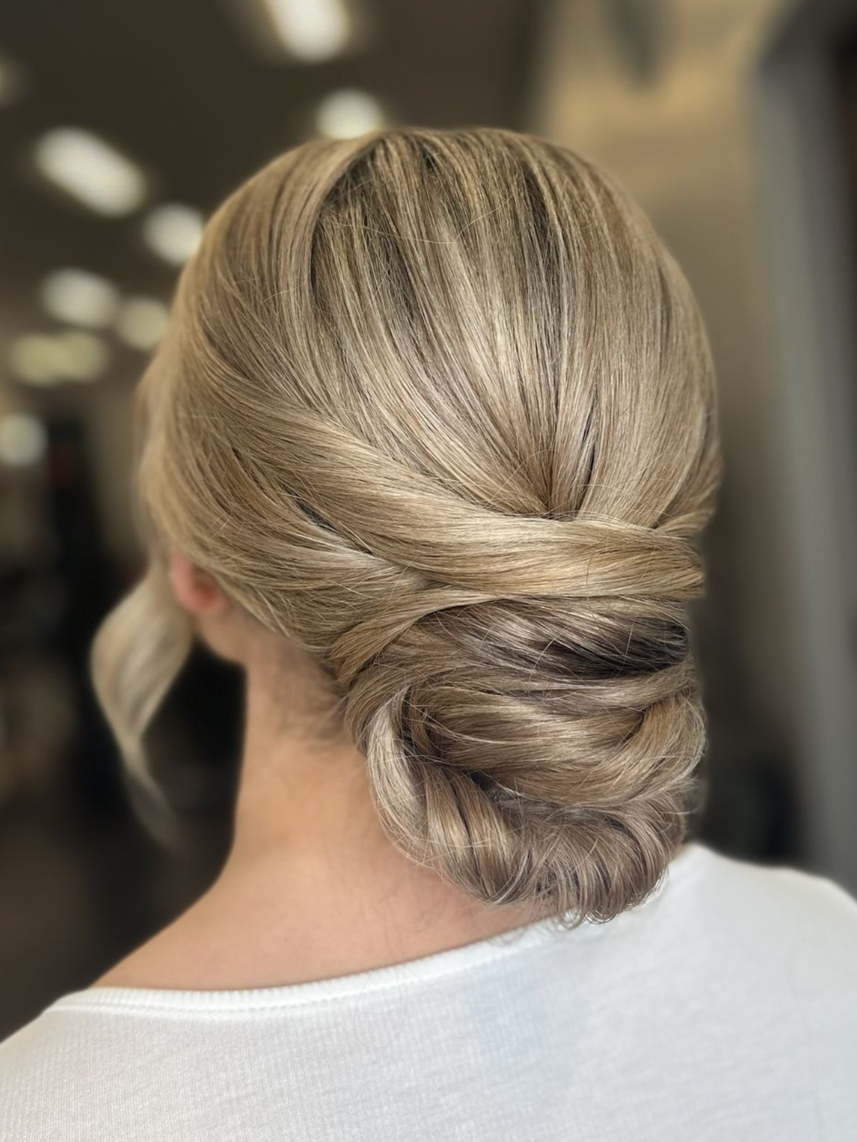 Esmeralda styling a client's hair with rollers