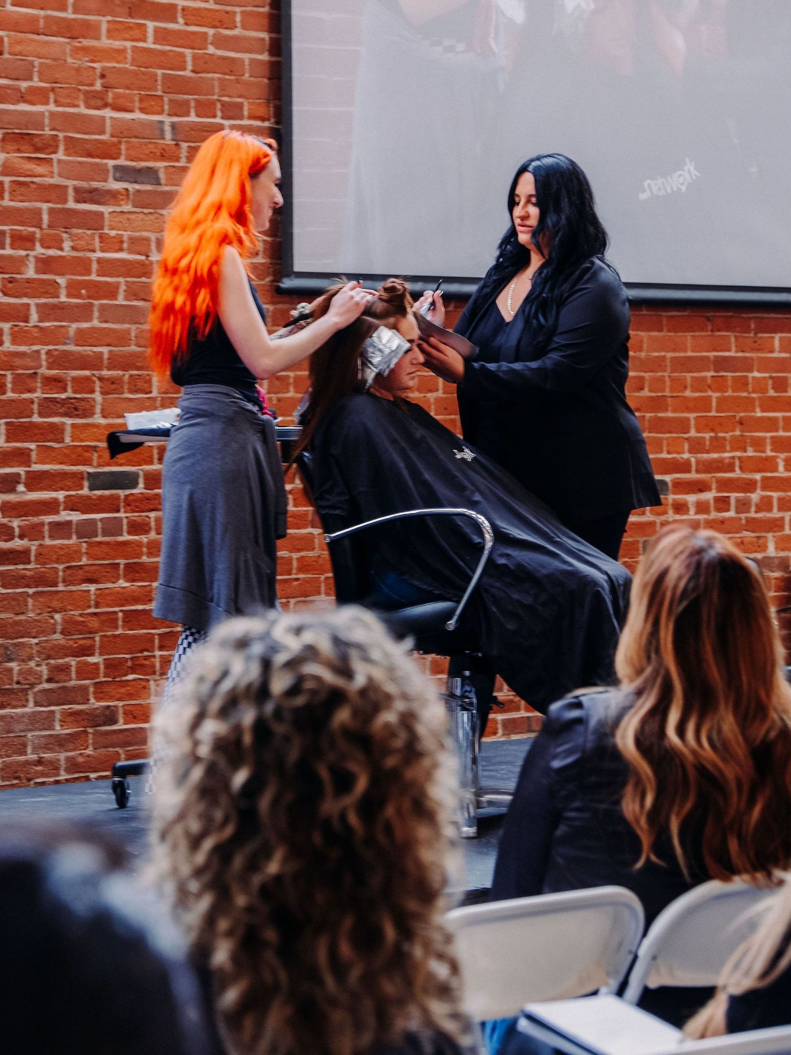 Esmeralda styling a client's hair with rollers