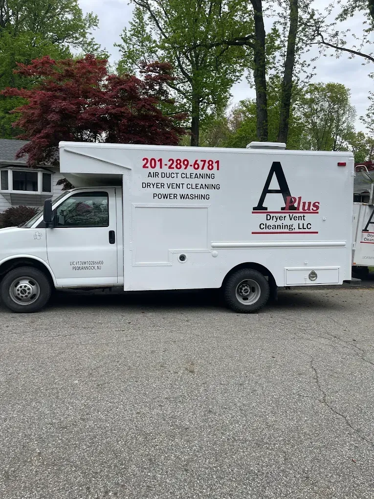 White A Plus Steam Cleaning truck parked on a paved road. The phone number is visible.