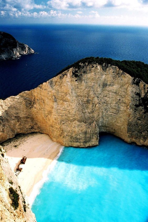 A large body of water surrounded by rocks and trees