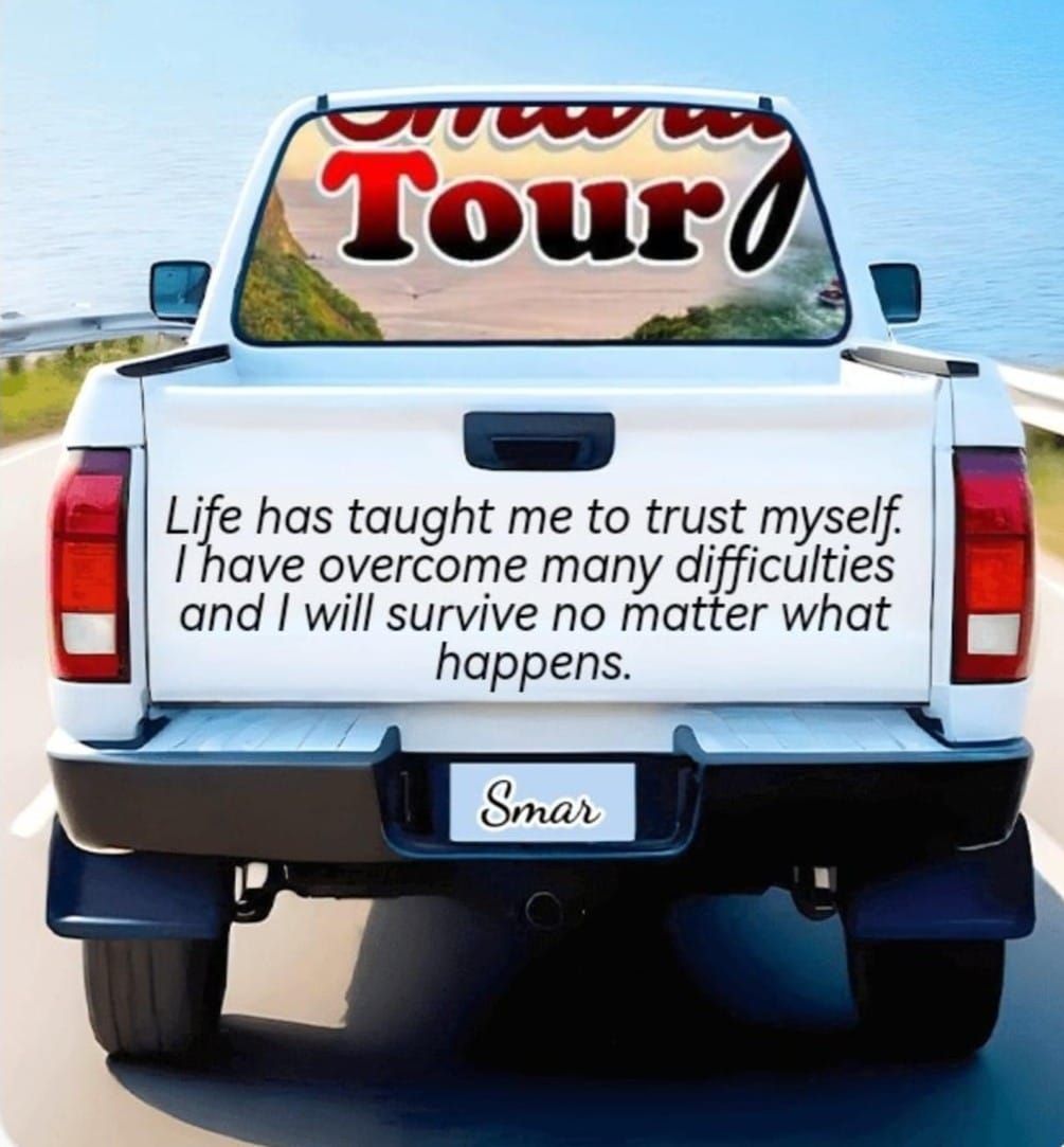 A white truck with a sticker on the back that says 