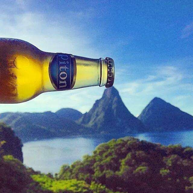 A bottle of piton beer with mountains in the background