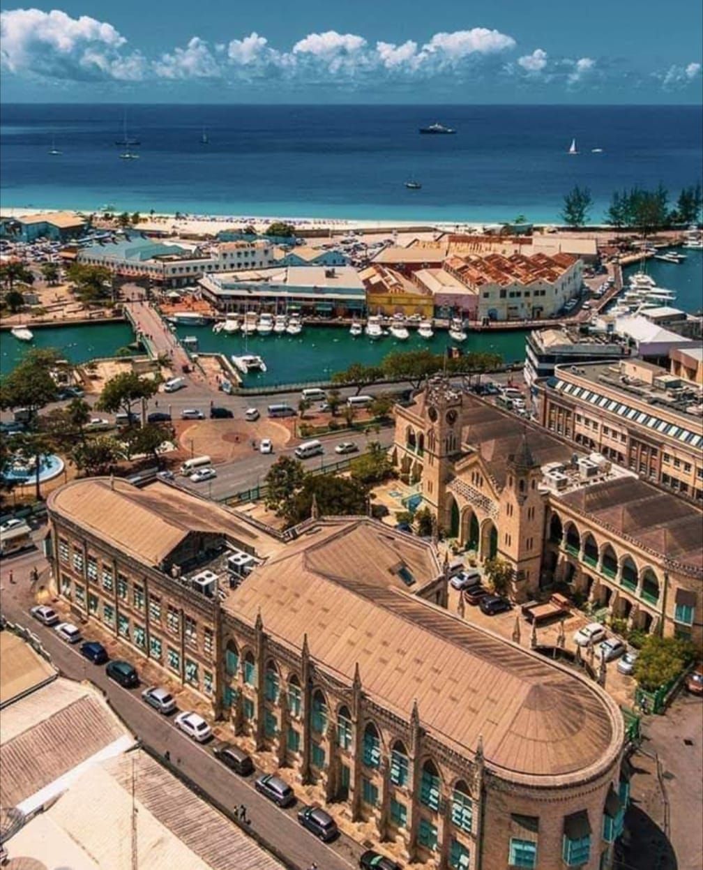 An aerial view of a city with lots of buildings and boats in the water.