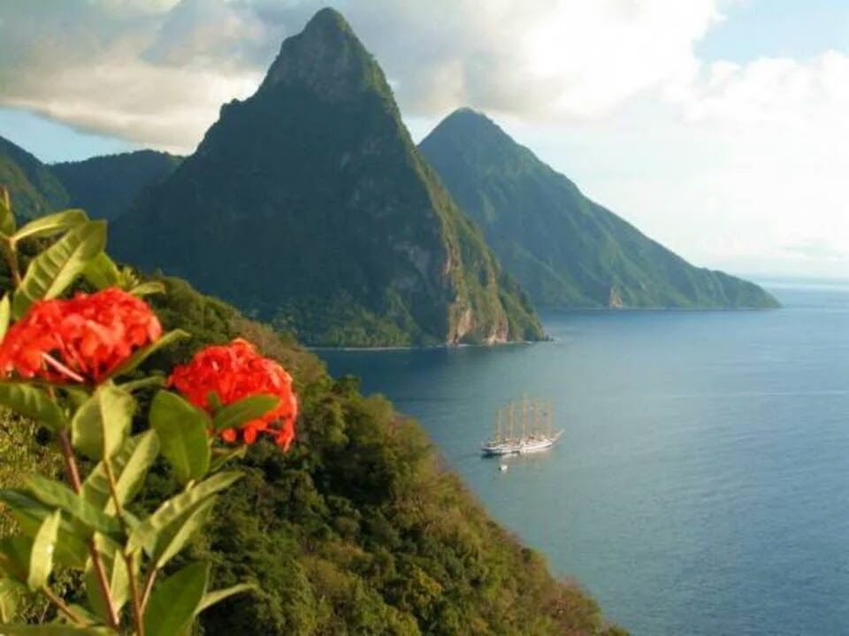 A boat is floating on the water near a mountain