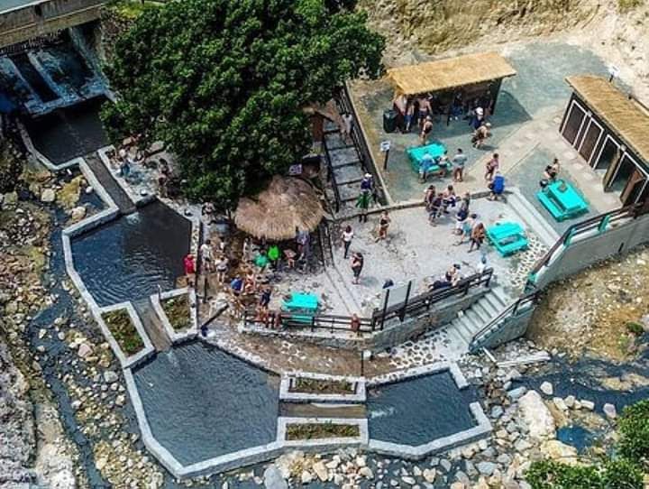 An aerial view of a swimming pool with people sitting around it.