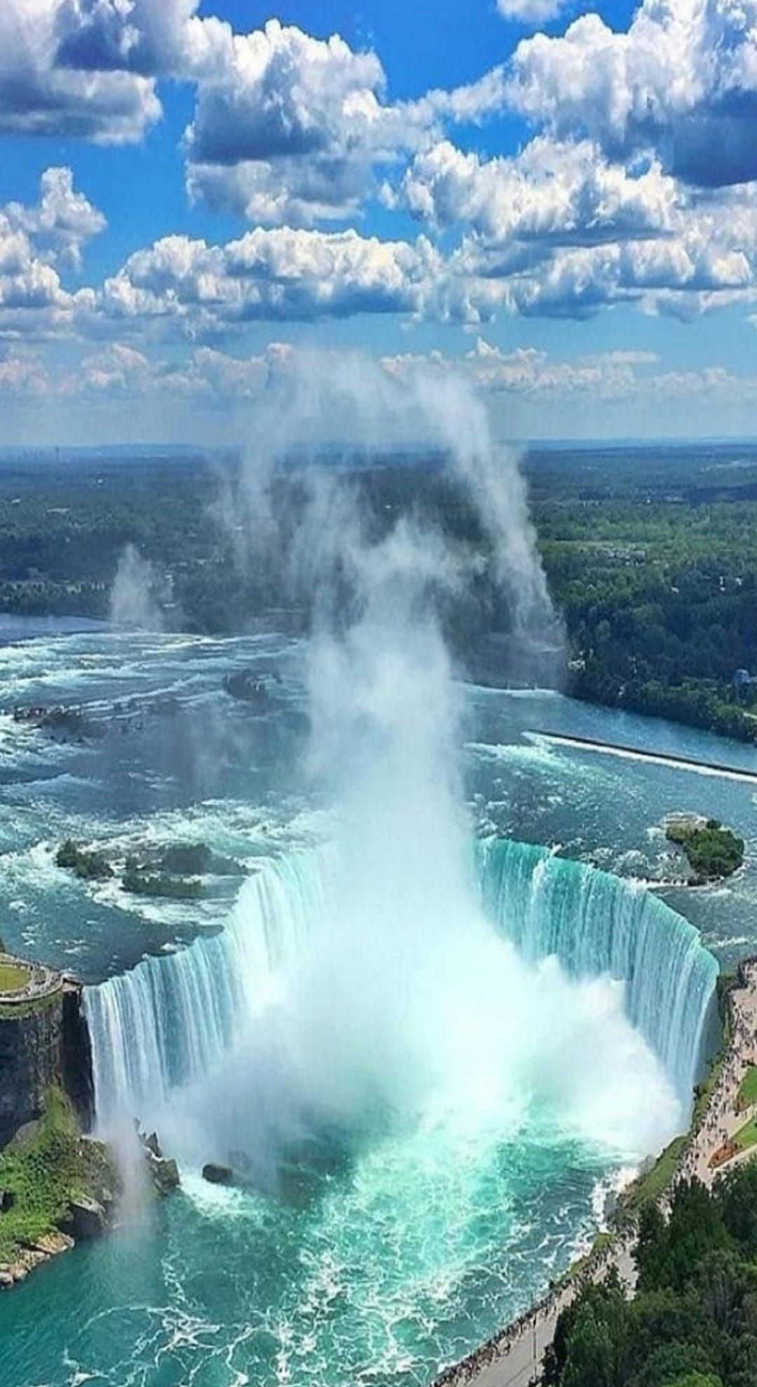 An aerial view of niagara falls on a sunny day.