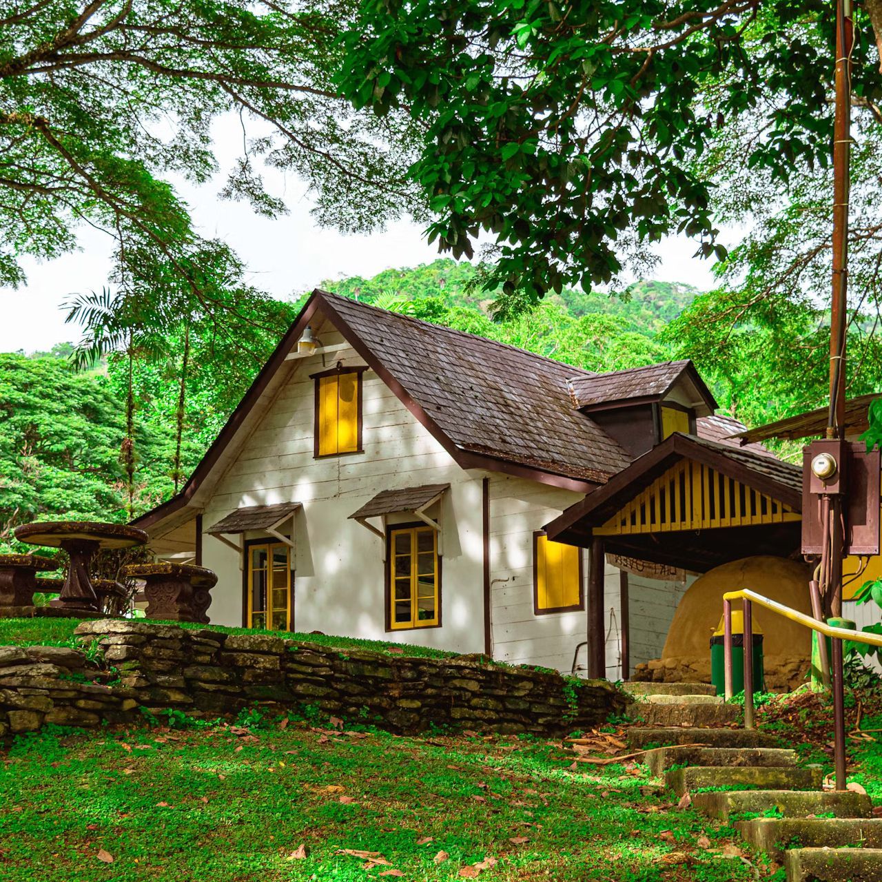 A small white house with stairs leading up to it