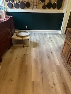 A kitchen with hardwood floors and a microwave.