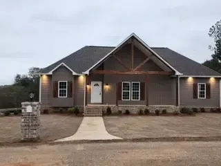 A large house with a lot of windows and a driveway in front of it.