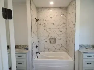 A bathroom with a bathtub and a shower.