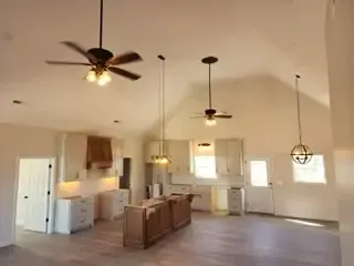 A kitchen with a ceiling fan hanging from the ceiling.