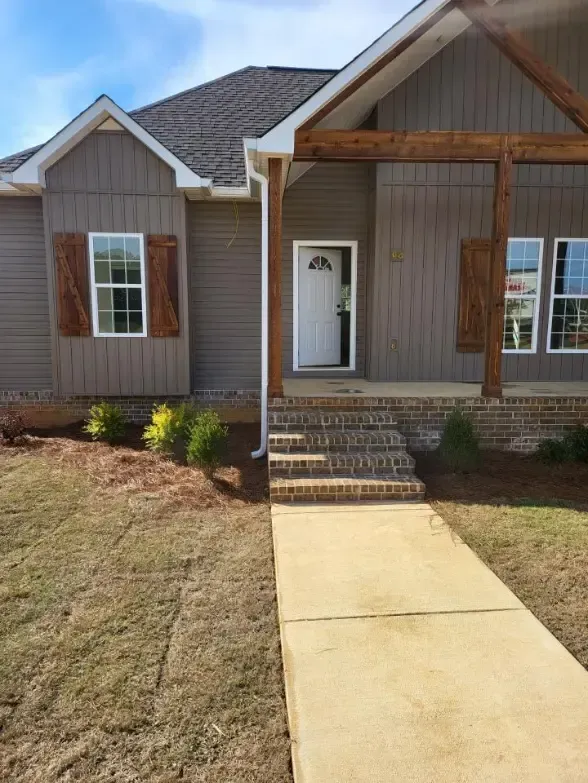 The front of a house with a walkway leading to it.