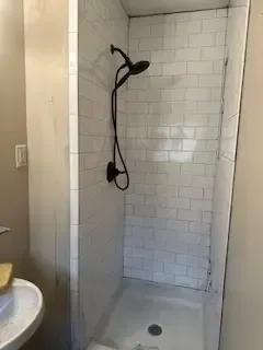 A bathroom with a shower and a sink.