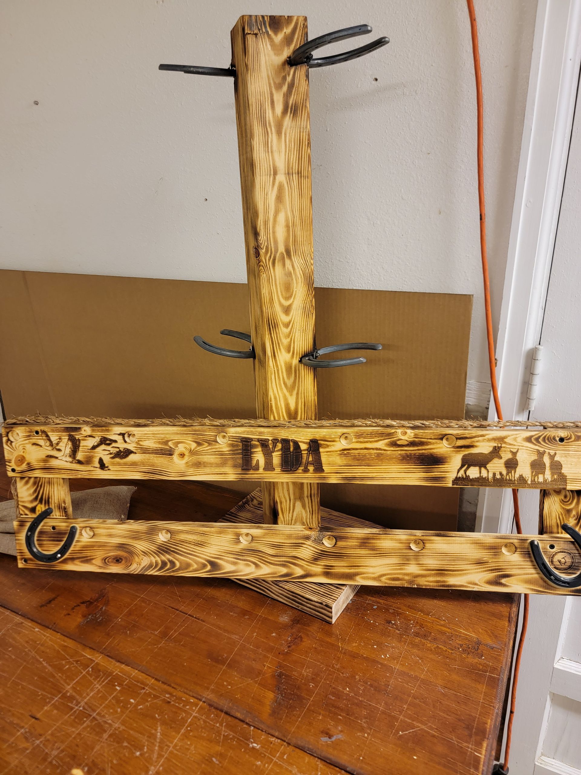 Wooden hunting rack with metal hooks and 