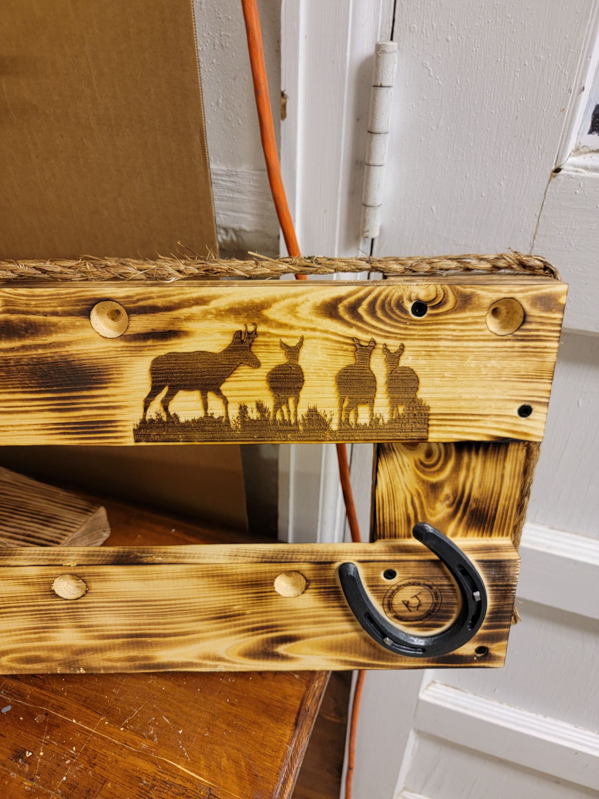 Wood key holder with burnt wood finish, deer silhouette, and horseshoe hook.