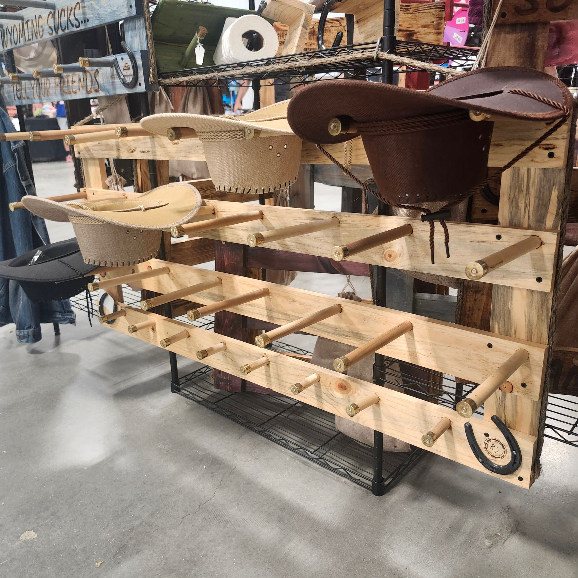 Wooden hat display made from pallet, holding cowboy hats.