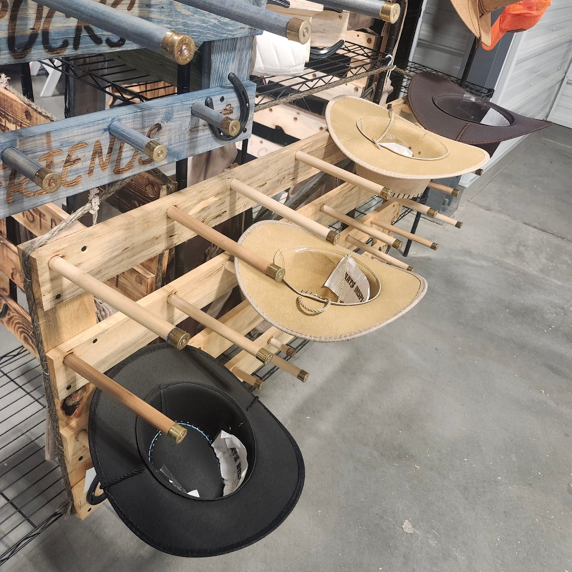Wooden hat display rack with cowboy hats.