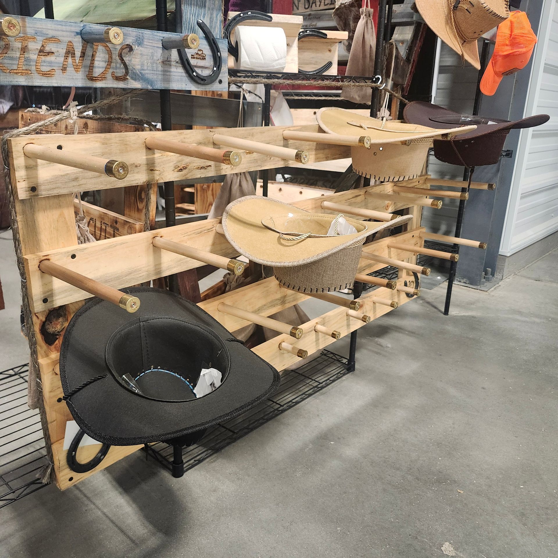 Wooden hat rack with various hats displayed.