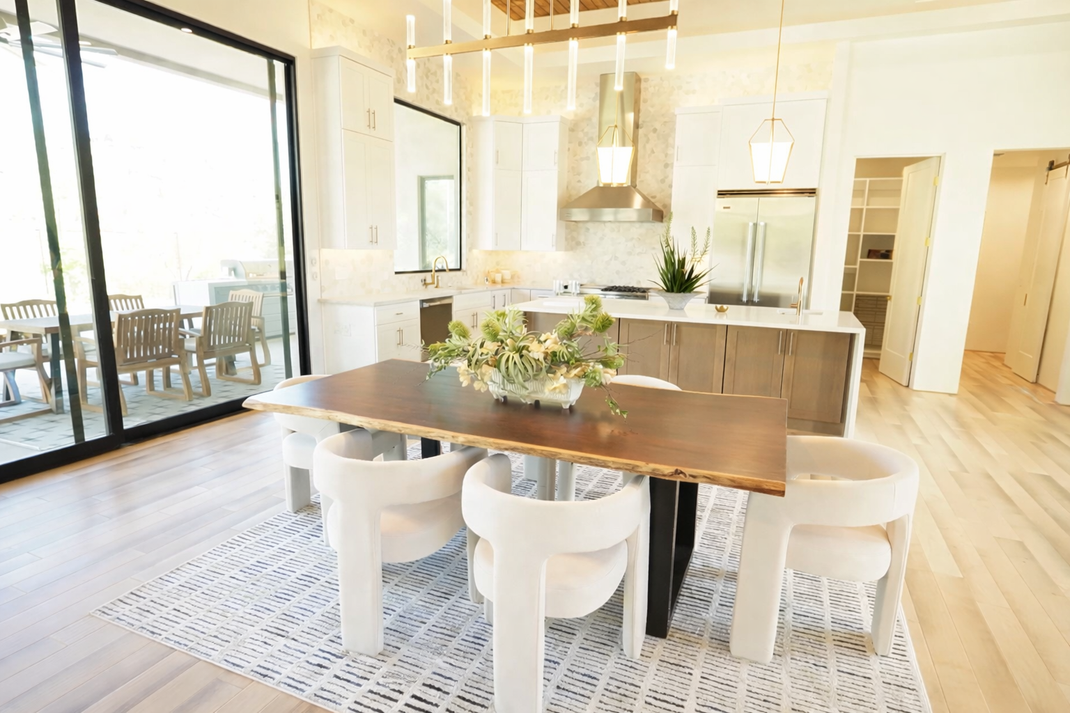 Modern dining and kitchen with a 10-foot Taj Mahal quartzite island in Mountain Dove, AZ