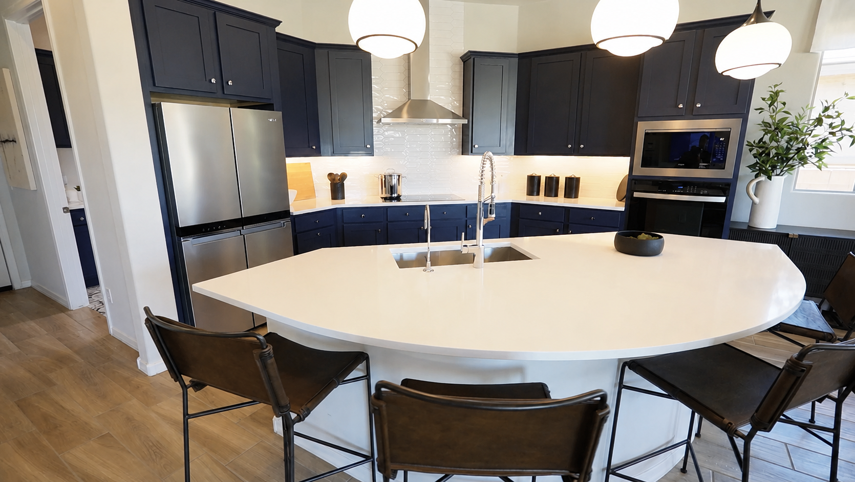 Pursuit Floor Plan's gourmet kitchen with half-crescent island and blue cabinets - Del Webb, Rocking K, AZ