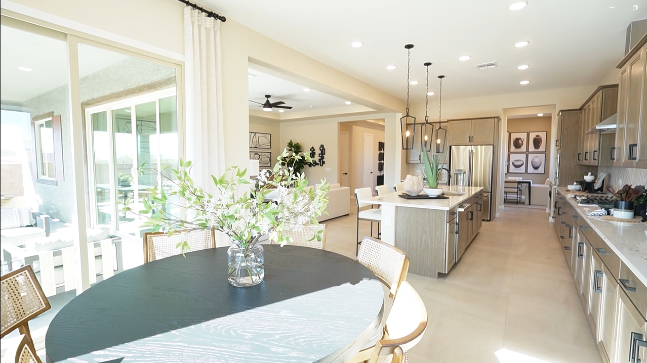Sunlit kitchen and great room designed for comfort and style — Cassandra model by Richmond American Homes in Tucson, AZ.