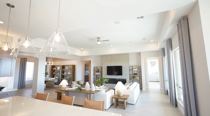 Voyage model home's open-concept design from kitchen to living room in Dove Mountain