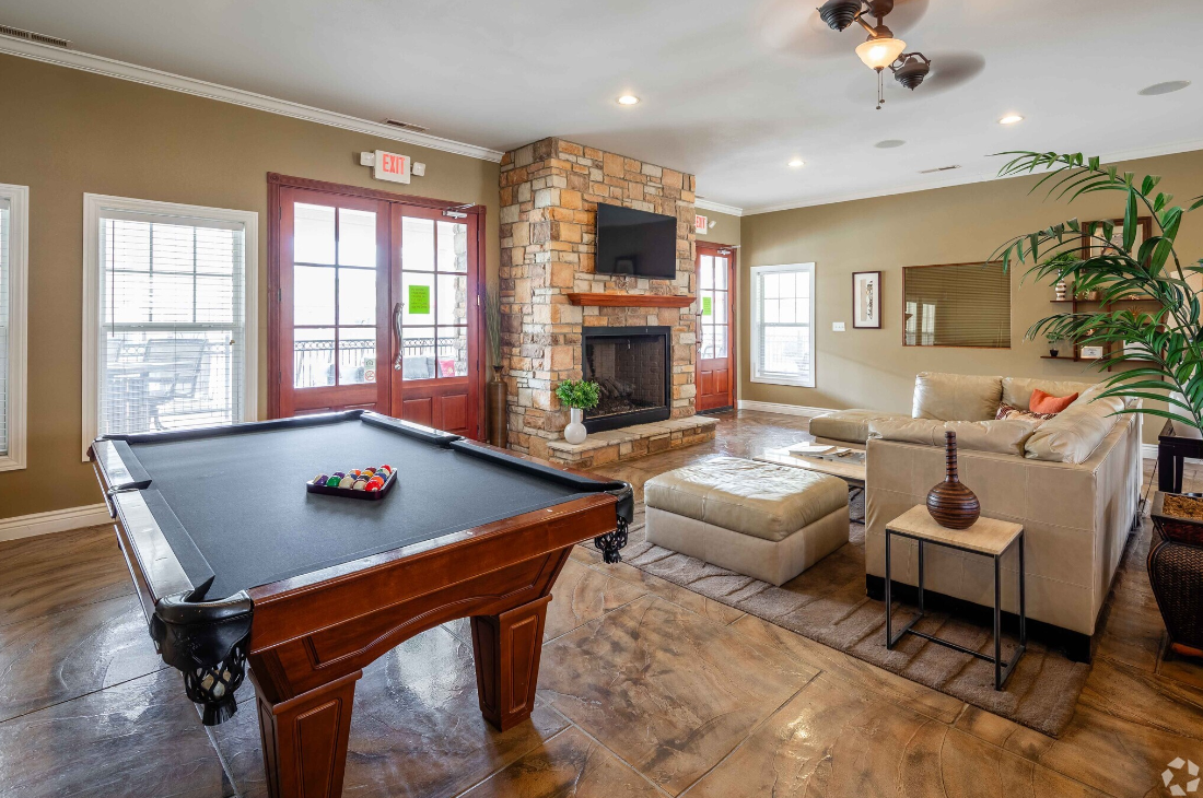 There is a pool table in the middle of the living room.