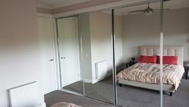 steves affordable shower screens glass doors reflecting the bed