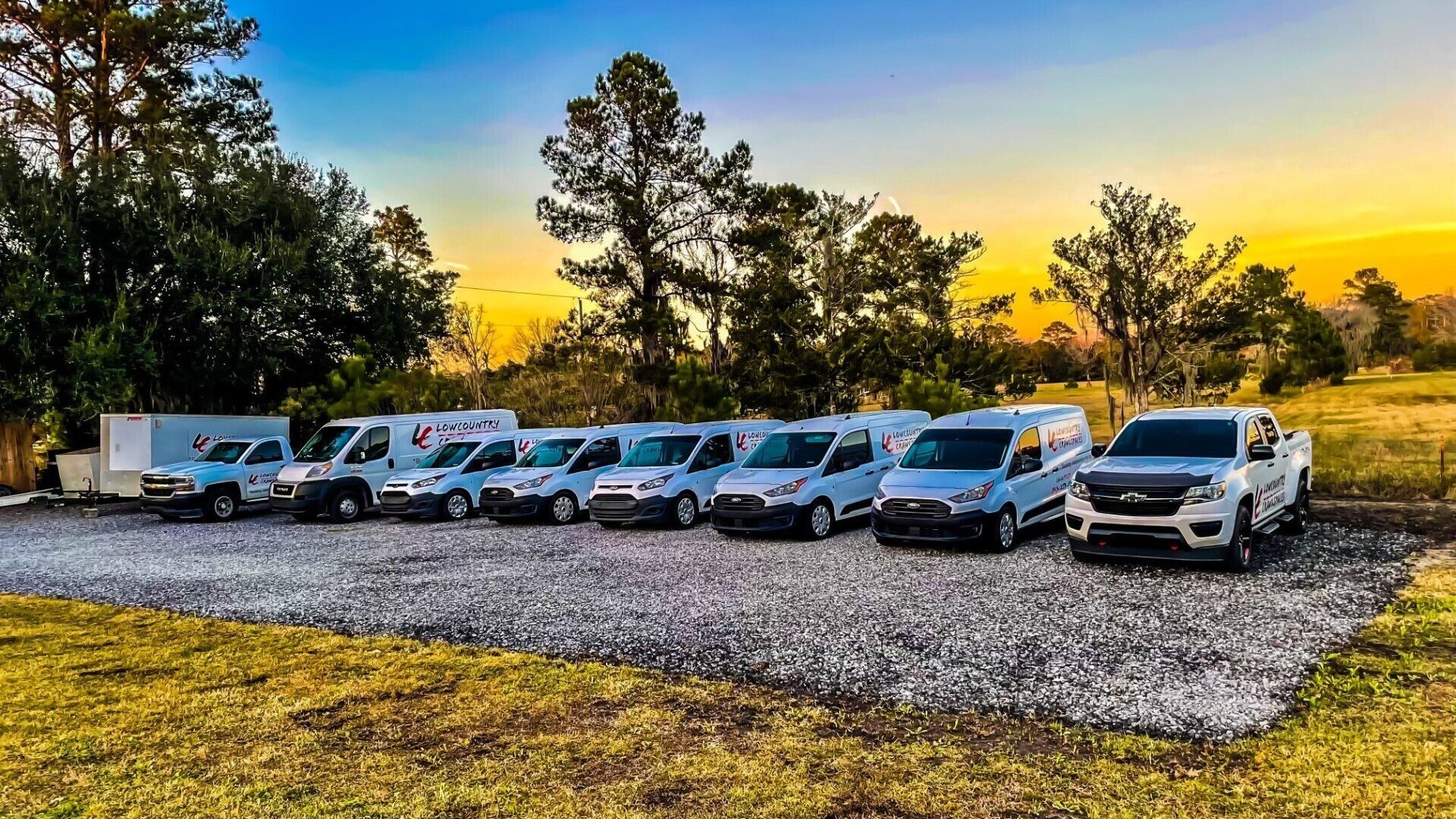 Lowcountry Crawlspaces fleet arriving on a Charleston jobsite to subcontract crawl space work