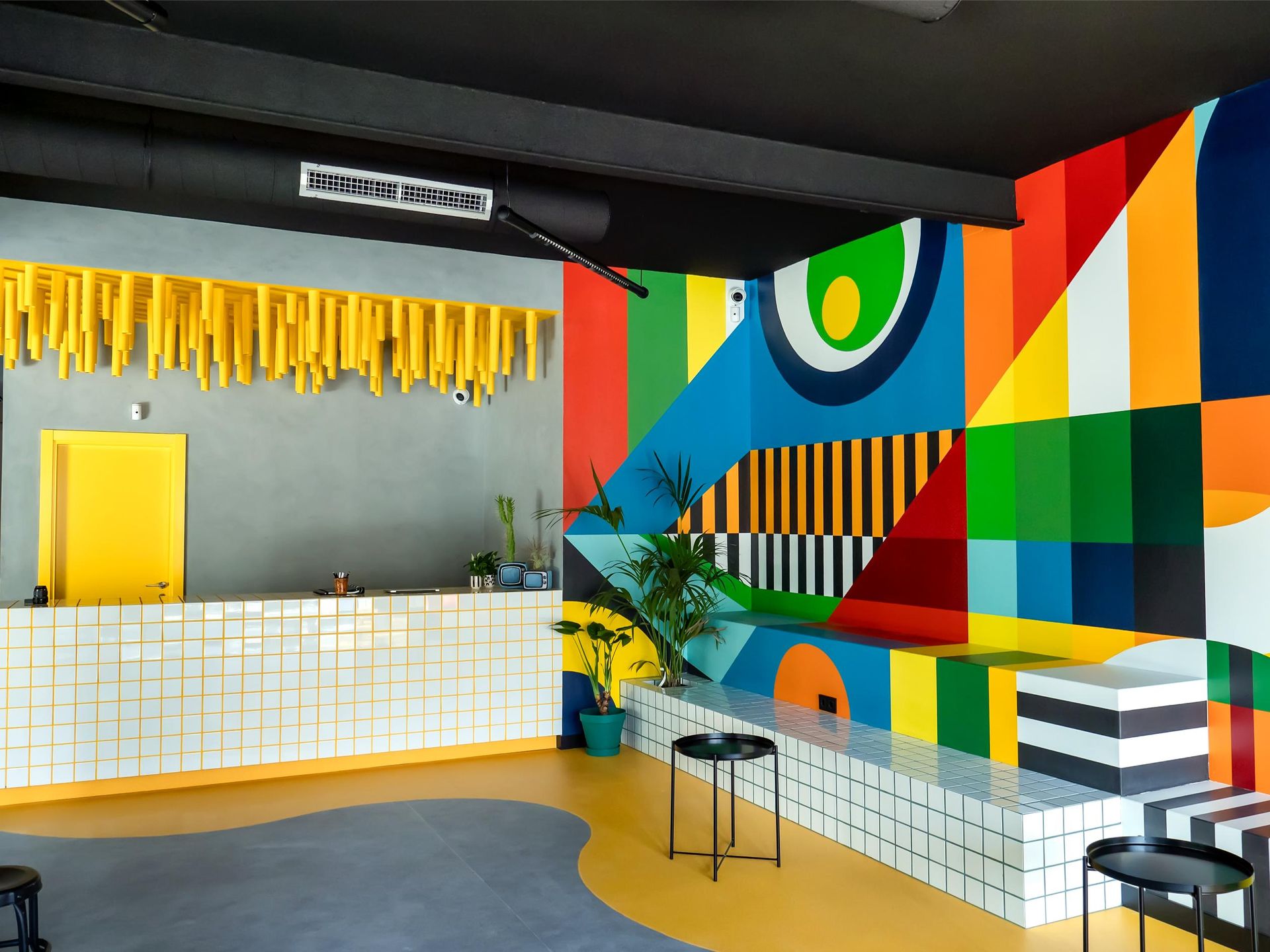 A room with a colorful mural on the wall and a counter.