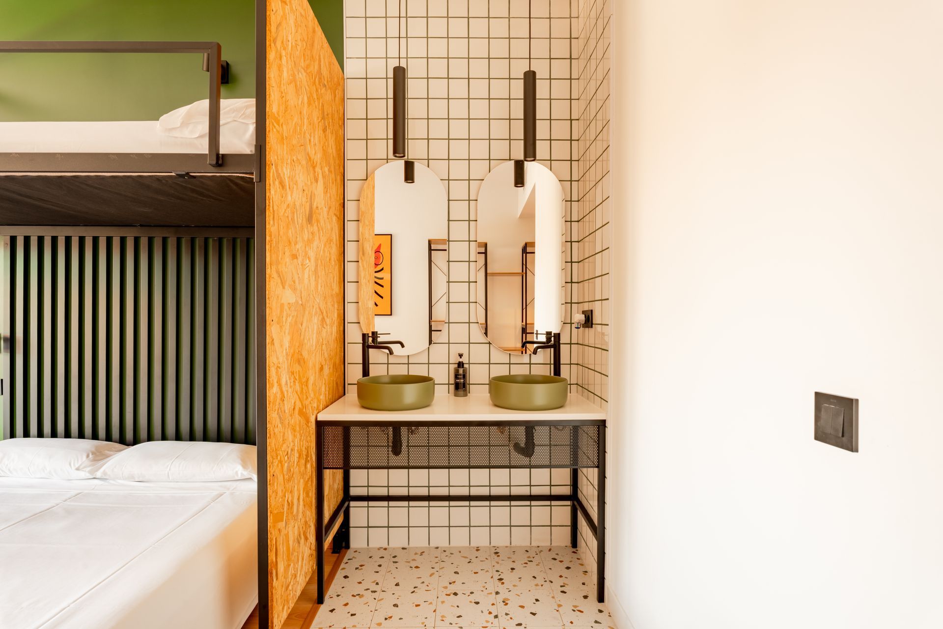 A bathroom with two sinks and a bunk bed.