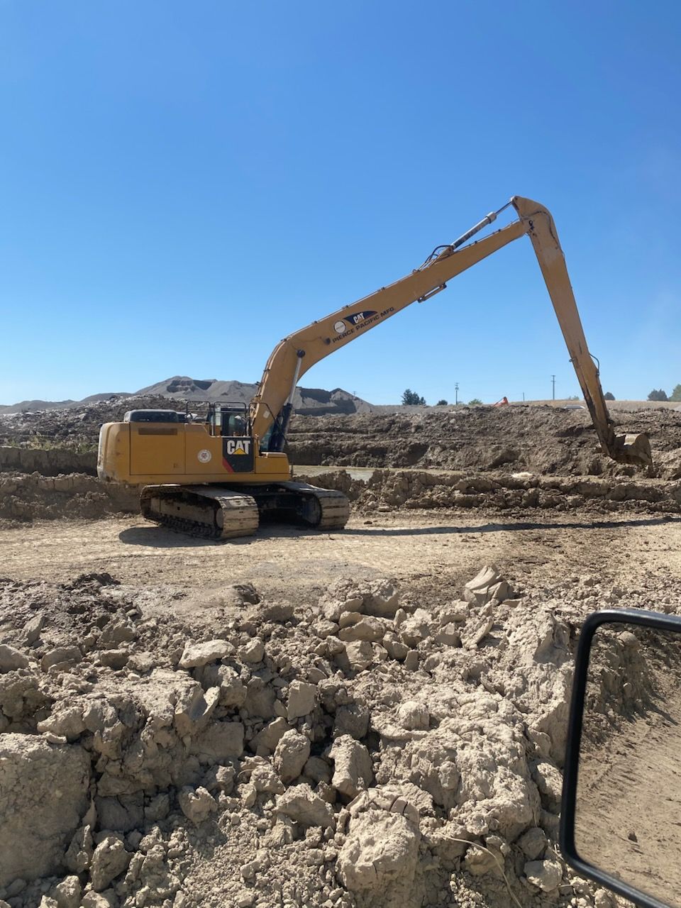 High-reach excavator performing safe demolition work in Utah.