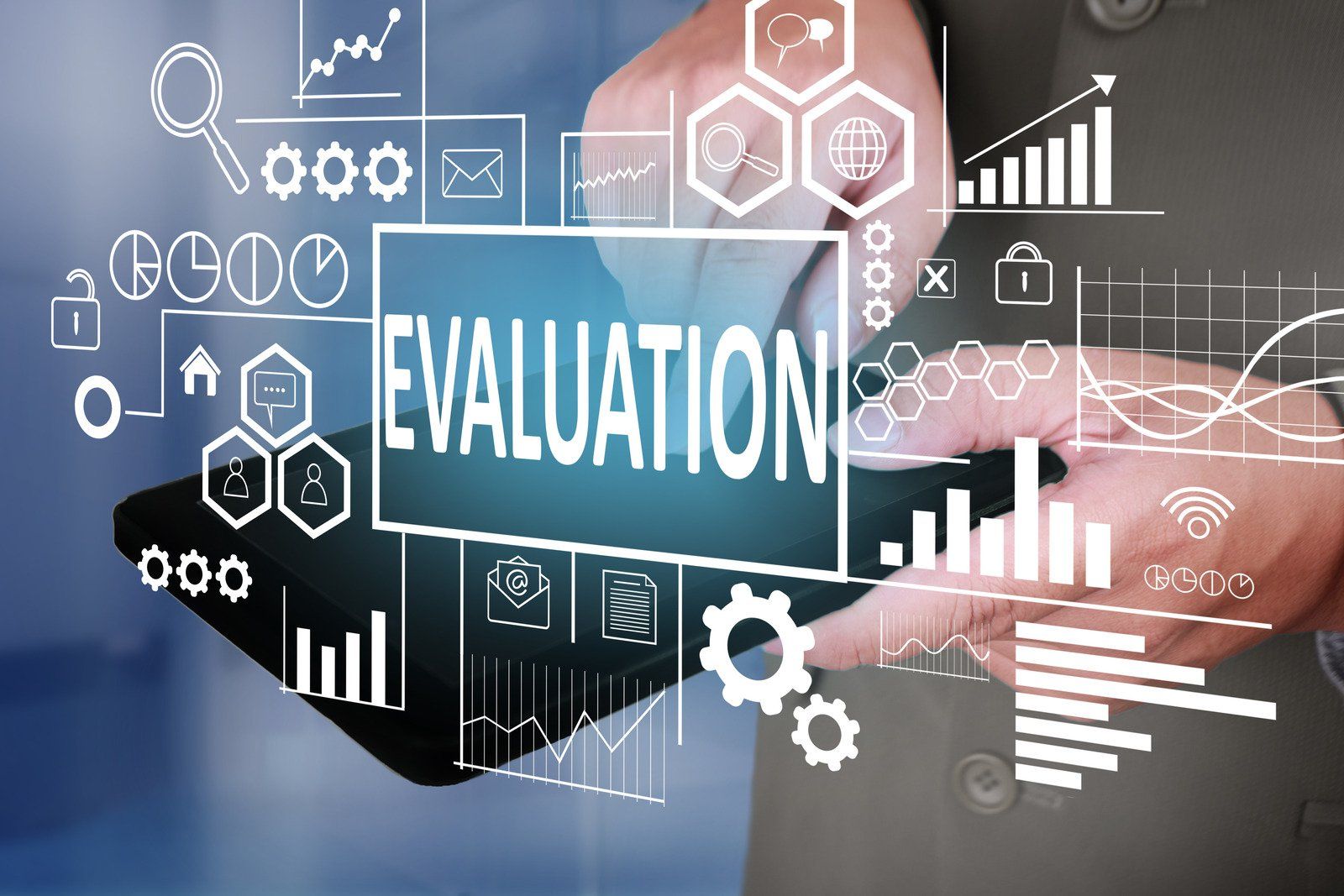 A person is holding a tablet with the word evaluation on it.