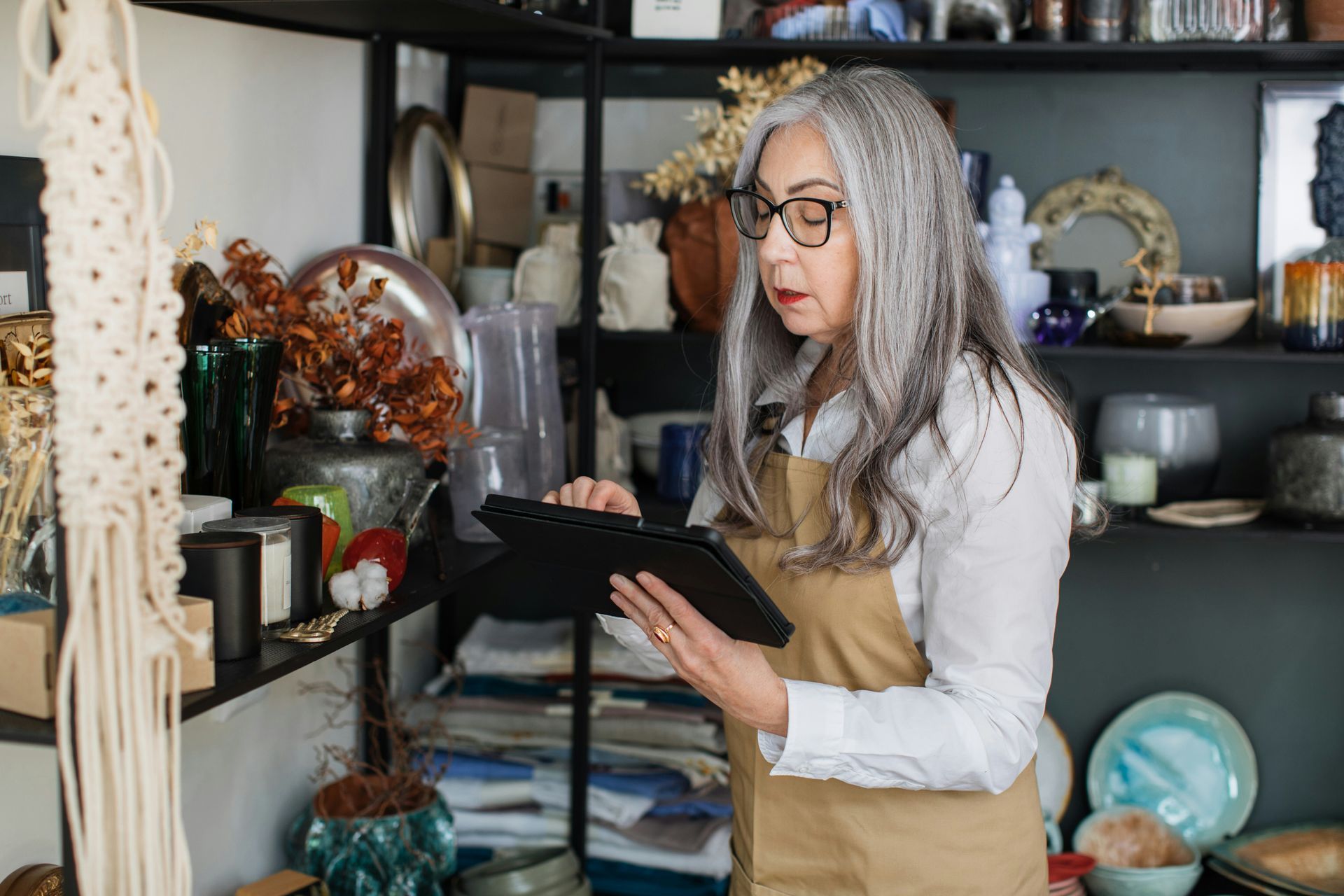 A woman is using a tablet in a store.