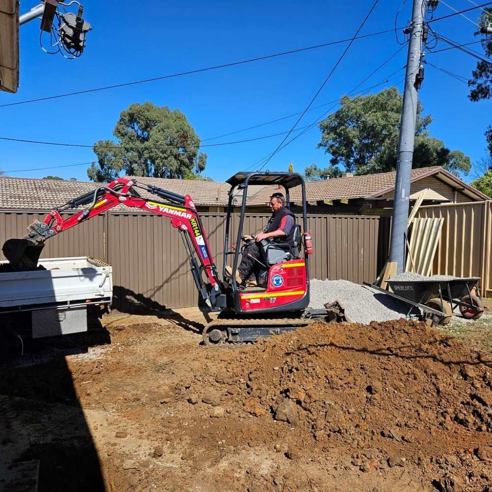 A Worker in an Excavator — Around Town Plumbing Services in Canberra, ACT