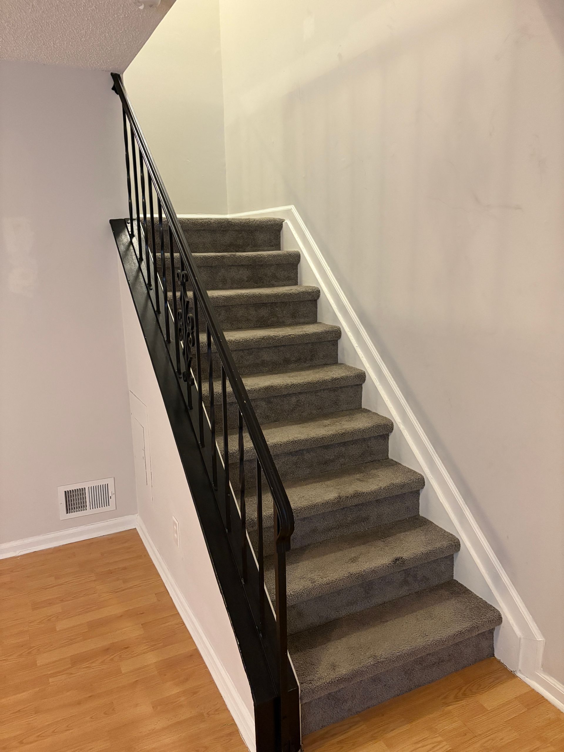 Staircase with wrought iron railings