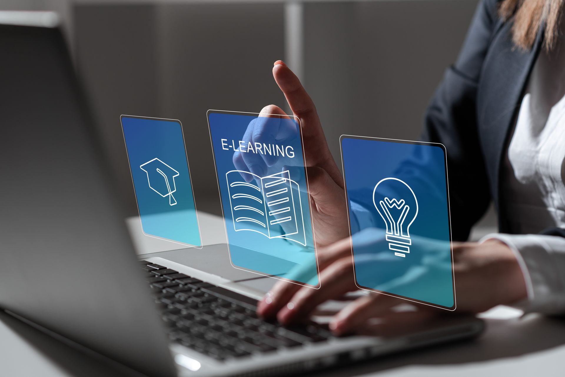 A woman is typing on a laptop computer with a light bulb coming out of her hand.
