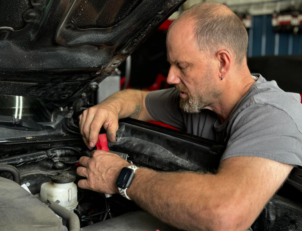 Mechanic in Cedar Rapids carefully inspecting and repairing a vehicle’s brakes.