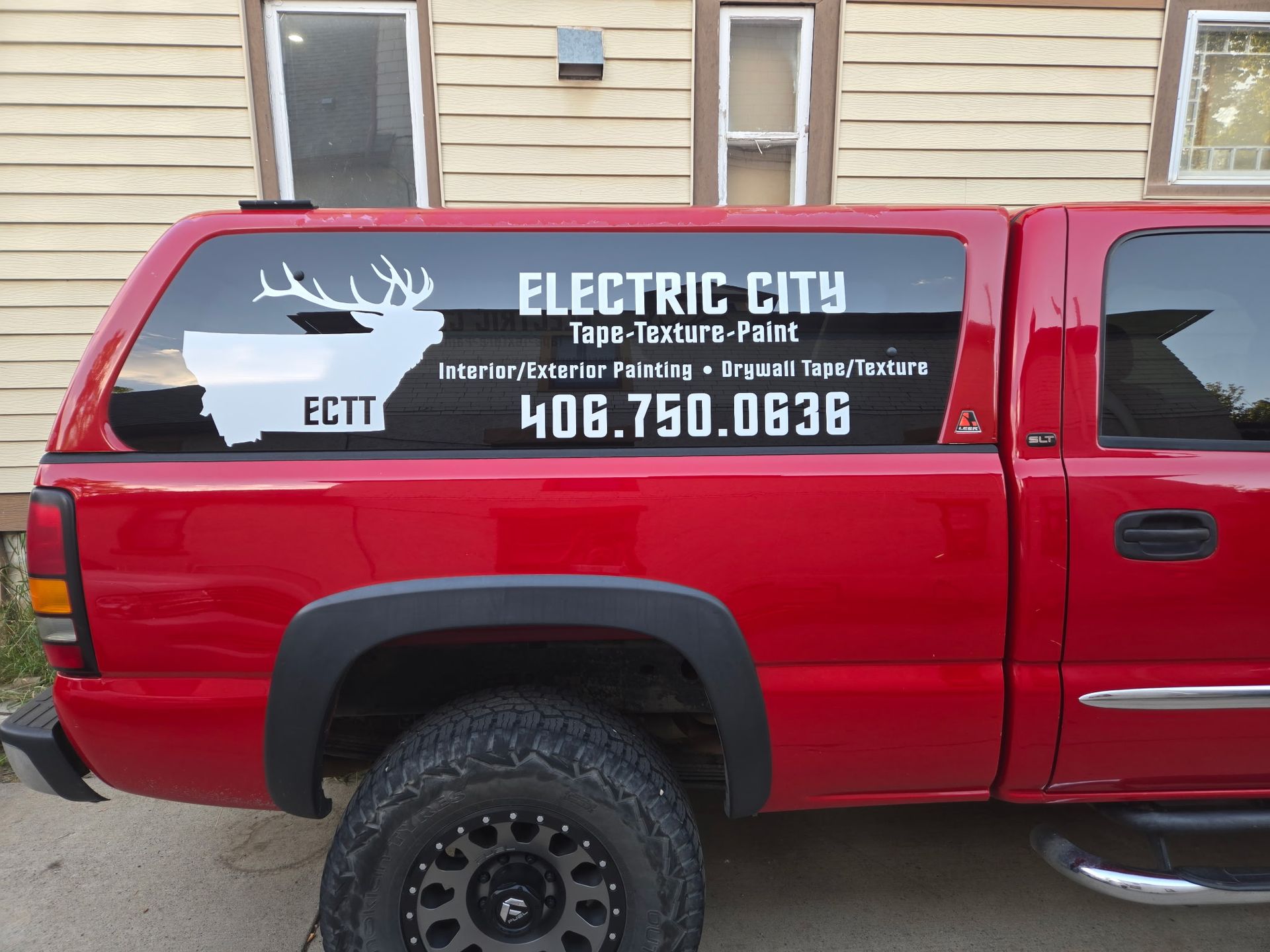 Red truck with a white decal advertising 