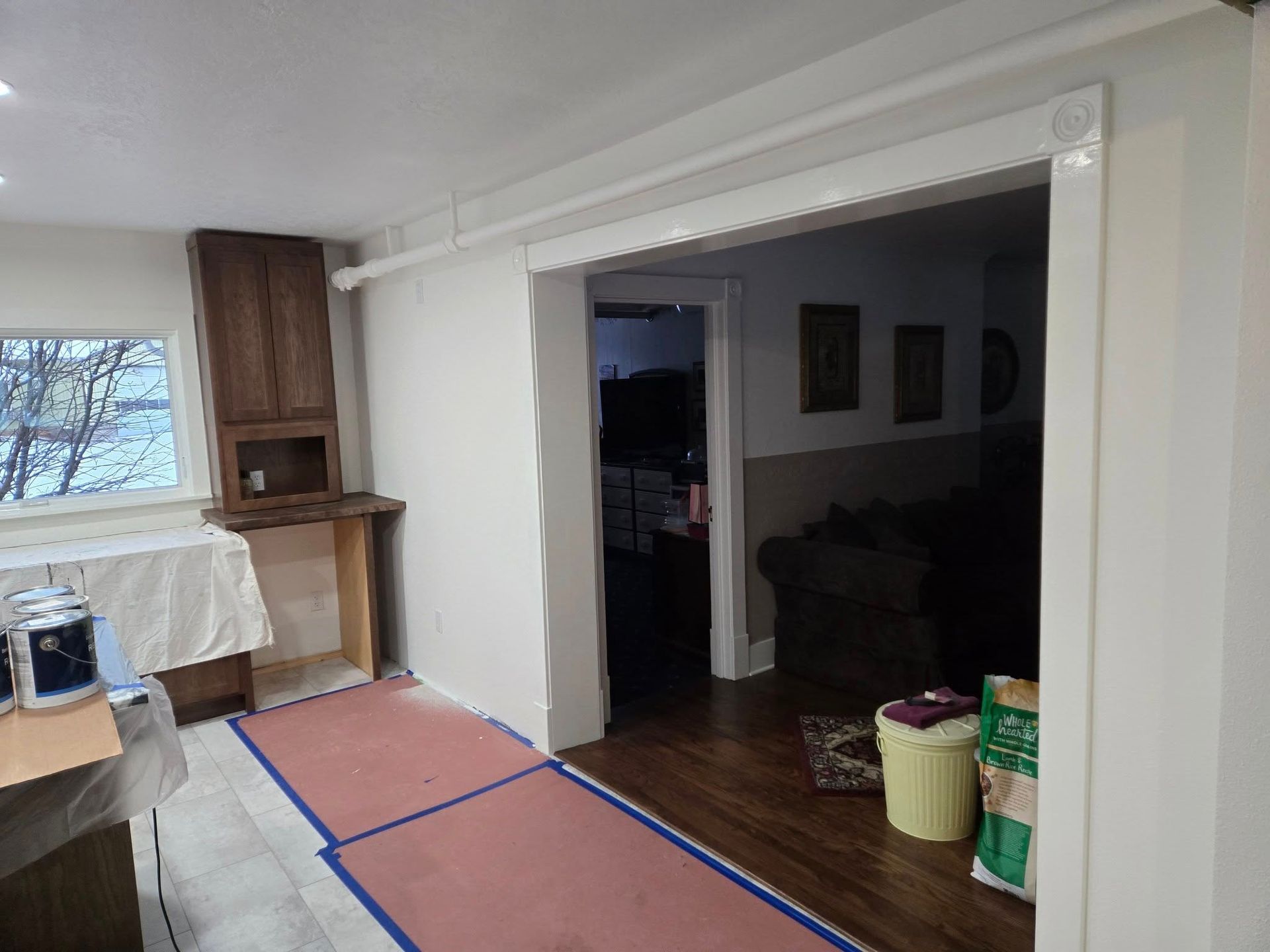 Interior view showing a doorway, kitchen, and a partially built counter.