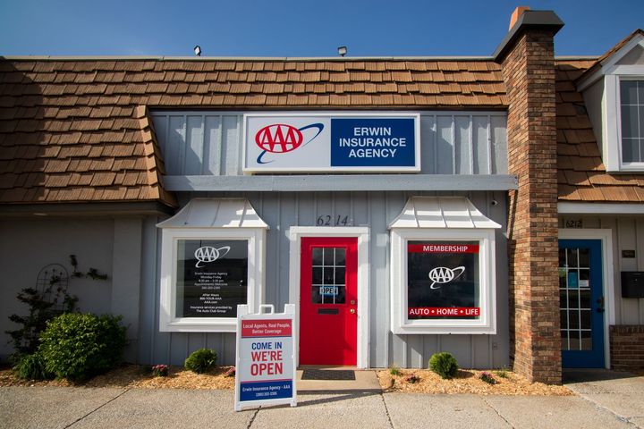 The Erwin building storefront with a red door and a sign that says Erwin insurance agency