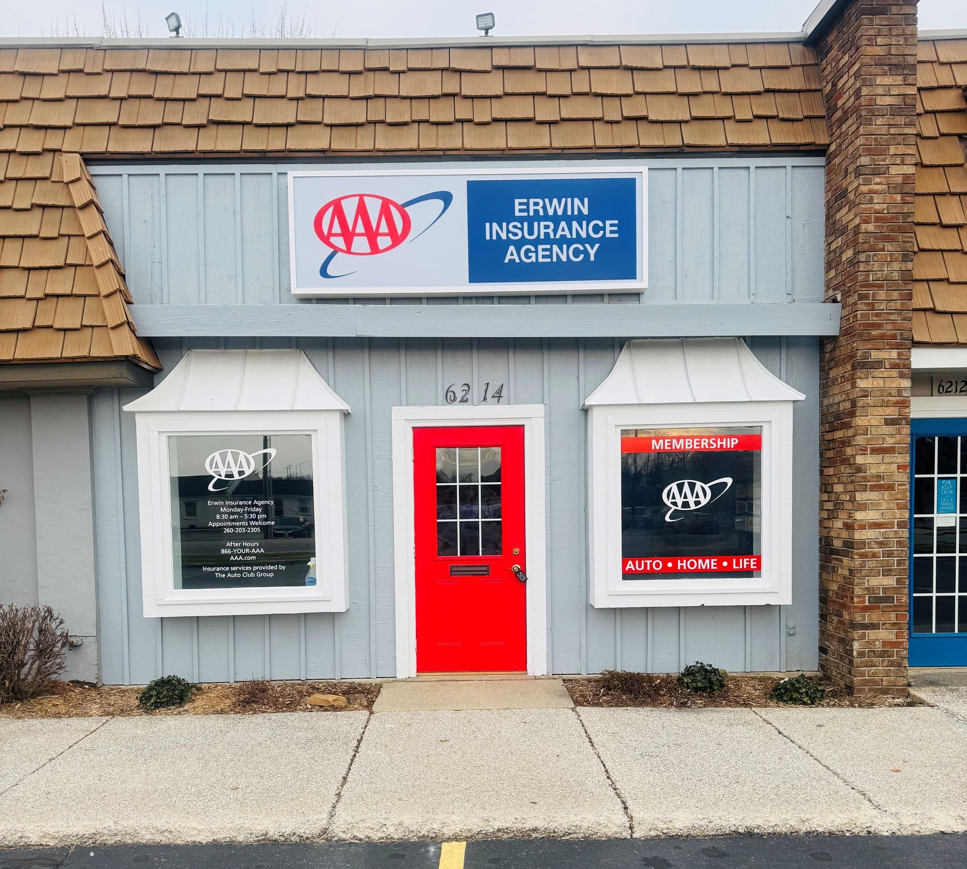 The Erwin building storefront with a red door and a sign that says Erwin insurance agency